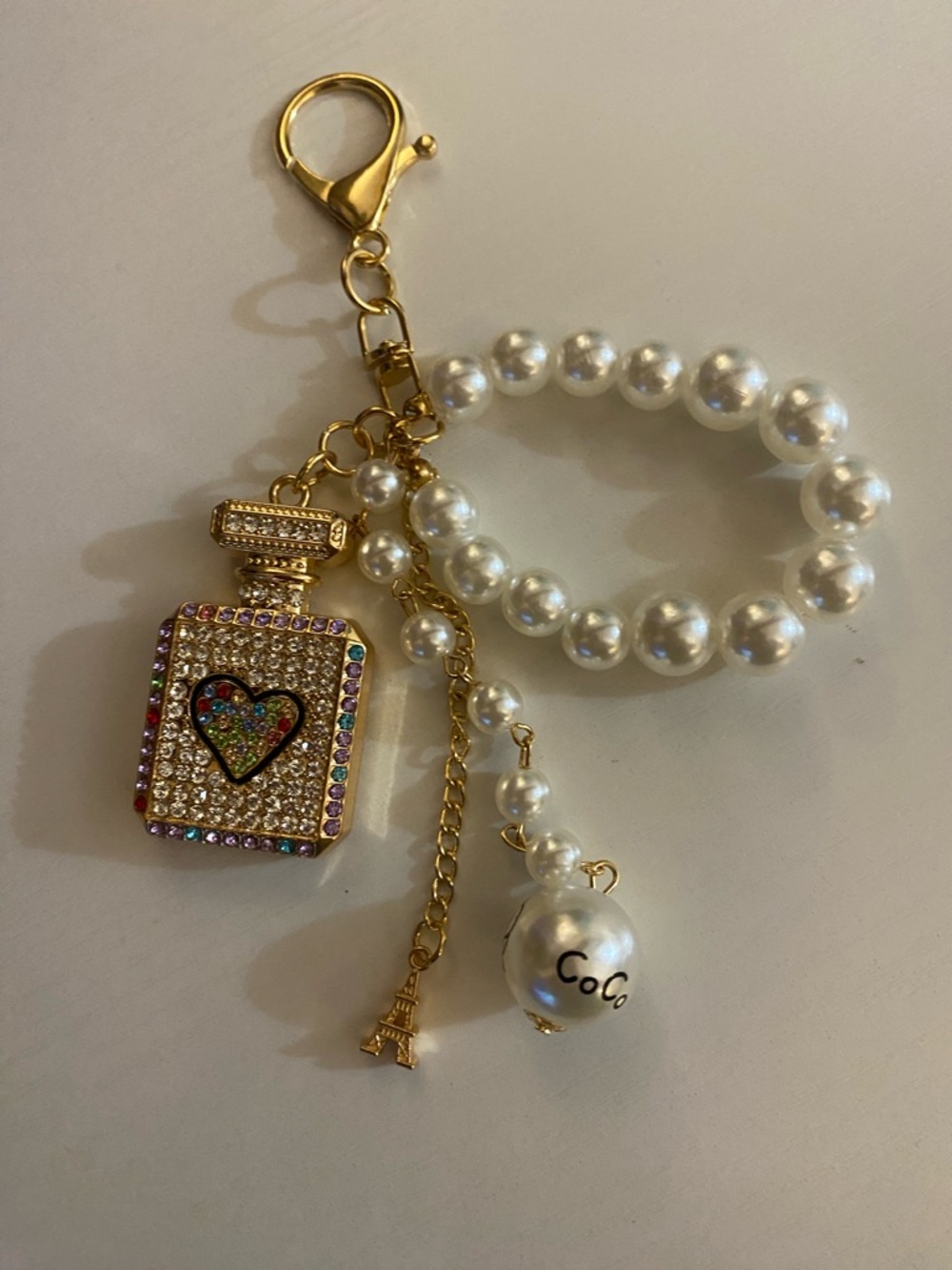 Pearl Bead Purse Charm with Gold Perfume Bottle and Eiffel Tower Accents